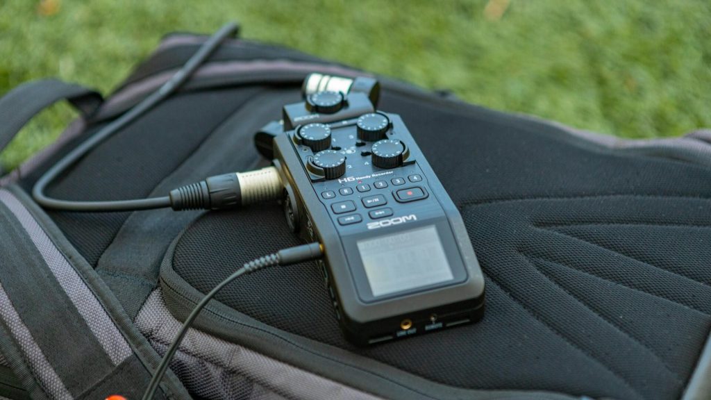 A Zoom H6 Handy Recorder on top of a backpack